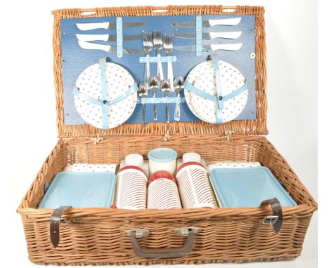 A retro mid 20th century picnic garden hamper. Having serrated knives, forks, spoons, saucers, side plates (trios), condiment