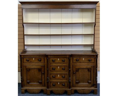 NORTH WALES OAK BREAKFRONT DRESSER - 19th century, painted interior deep shelf rack, the base with a T arrangement of six ope