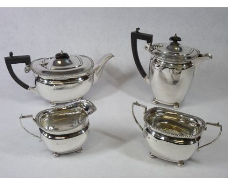 A FOUR PIECE SILVER TEA &amp; COFFEE SERVICE - each piece of oval plain form with four ball supports and with gadrooned top e