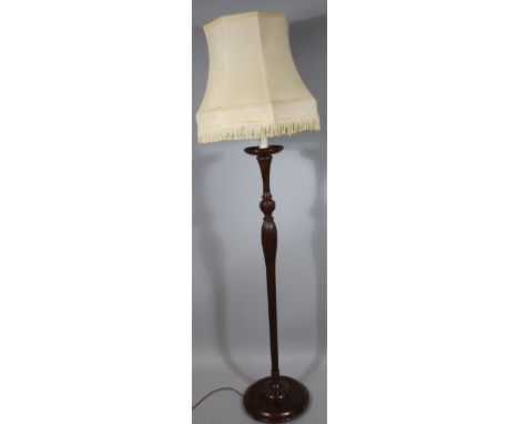 A 20thC beech stained standing lamp, with cream shade and modern fitting, above a heavily fluted stem, on compressed domed fo