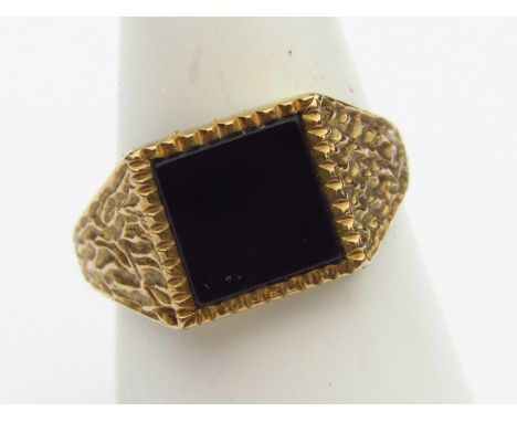 A 9ct gold signet ring, with polished green stone centre and part textured shank. 