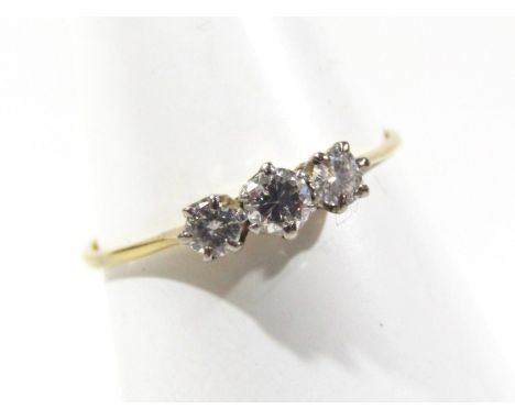 A diamond three stone ring, on a plain shank, marked 18ct PLAT, size O, 
