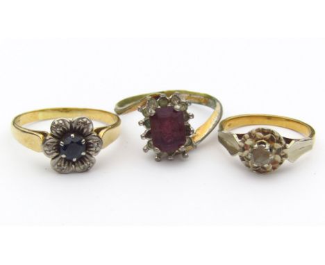 A ladies floral set dress ring, on a part pierced shank, marked 18ct, size R, and two other dress rings. (3)