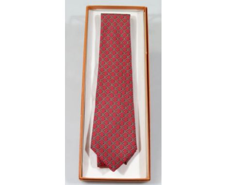 An original genuine Hermes gentleman's silk tie, no. 714FA, 100% silk in a repeat geometric pattern on red ground, (boxed), 3