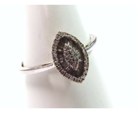 A marquise shaped diamond dress ring, set with round brilliant stones and baguette cut stones, white metal, marked 750, 1.9g 