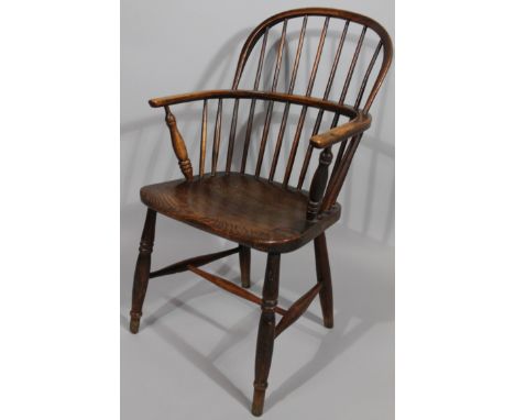 A 19thC ash and elm low back Windsor chair, with curved arm supports and double ring topped front legs, joined by a 'H' stret