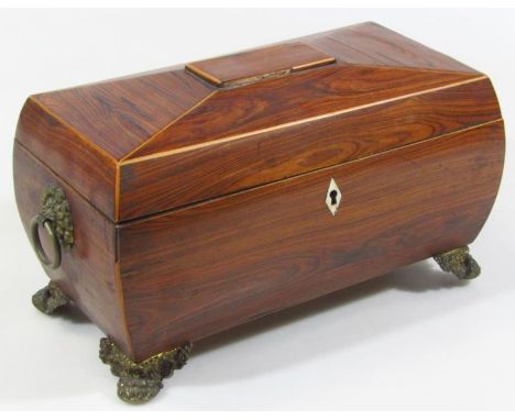 A Regency rosewood tea caddy, the sarcophagus shaped lid hinging to reveal a central section for mixing bowl flanked by two (