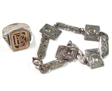 A gentleman's bi-colour signet ring, initialled to the centre, size R and a silver bracelet with pierced links broken by boat