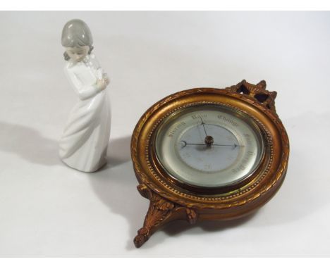 An elaborate wall barometer, in the neo-classical style, and a Nao figure (2)