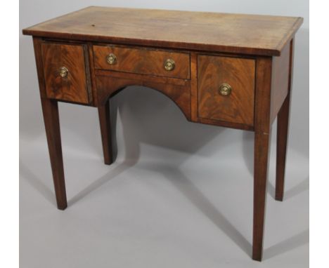 A 19thC mahogany desk or dressing table, with rectangular overhanging top raised above one shallow and two deep frieze drawer