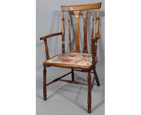 A 20thC polished Arts & Crafts style occasional chair, with inverted back set with mother-of-pearl finish roundels beneath an