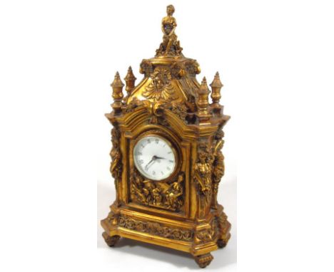 A 20thC rococo style gilt wood mantel clock, centred by a 7cm dia. dial in heavily carved case, with basic movement, surmount