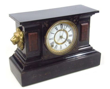 A late 19thC black slate and marble mantel clock, centred by a 11cm Roman numeric dial with eight day movement, flanked by li