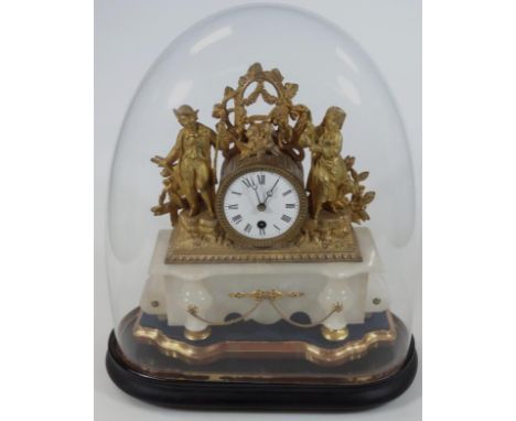 A 19thC gilt metal mantel clock, with central 8cm dia. Roman numeric dial, flanked by figures and surmounted by scrolls and g