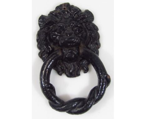 A 20thC cast metal lion's head door knocker, with ropetwist circular articulated section painted black, 16cm high. 