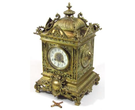 A 19thC rococo design mantel clock, with 8cm dia. dial, with Arabic numerals and an eight day movement revealing a highly ela