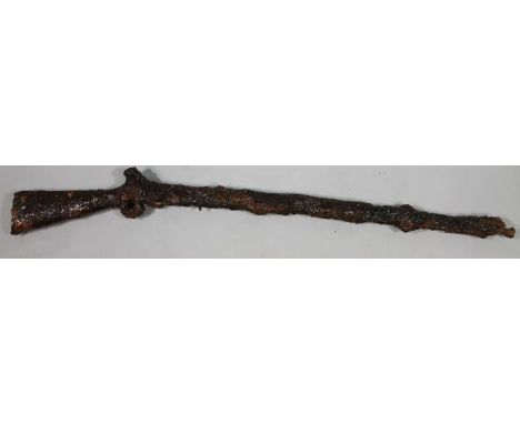 An early 19thC long barrelled rifle, Brown Bess type, found at sea off the Kent coast, with heavy crusting, pitting and other