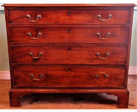 A 19th century mahogany chest of four long graduated drawers, with moulded top, swan neck brass handles on ogee bracket feet.