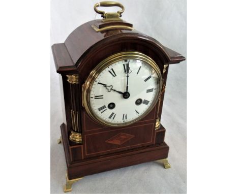 An Edwardian mahogany and brass inlaid mantle clock.   Condition Report:  No guarantees in working order.There is a key.