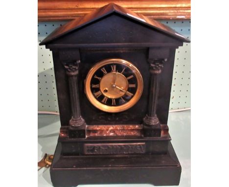 A large Victorian black slate mantle clock.