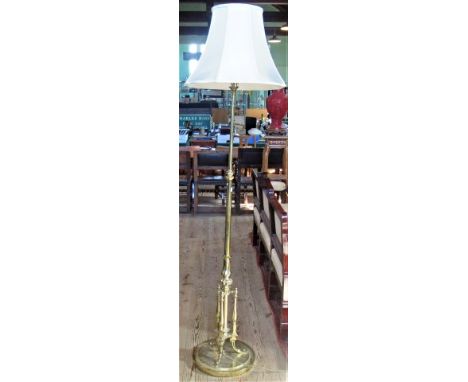 A Victorian-style brass adjustable standard lamp.