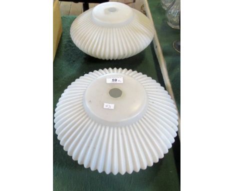 A pair of opaque glass ceiling light shades.