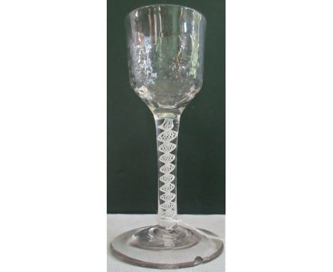 A 19th century opaque twist wine glass, with dimpled bowl on a ribbon and lattice corkscrew stem on conical foot, 14cm high. 