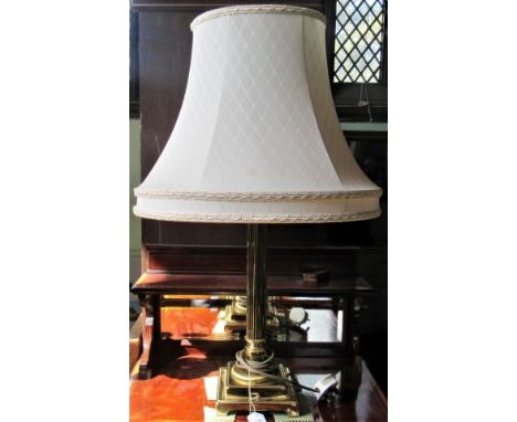 A contemporary brass Corinthian column table lamp.