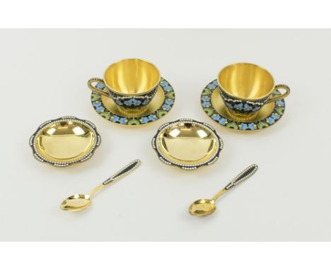 RUSSIAN TEAWARES, silver gilt and coloured enamels, comprising two teacups with saucers, two small dishes and a pair of teasp