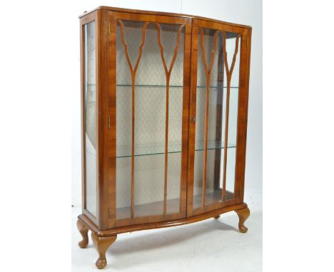 1930's Art Deco walnut China display cabinet vitrine. Raised on stub cabriole legs with pad feet having inset glass shelves. 