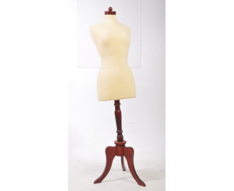 A contemporary traditional style tailors dummy mannequin. Raised on a mahogany pedestal base, with upholstered calico fabric 