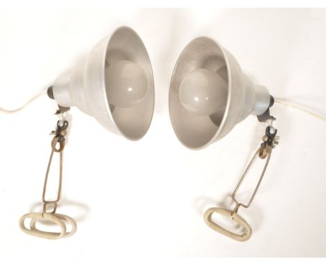 A pair of industrial Photax lamps with spring clamp attachments and aluminium conical shades.