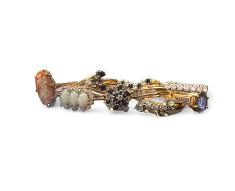 A collection of 9ct gold dress rings. To include a channel set diamond ring, size R 1/2; a sapphire and diamond cluster ring,