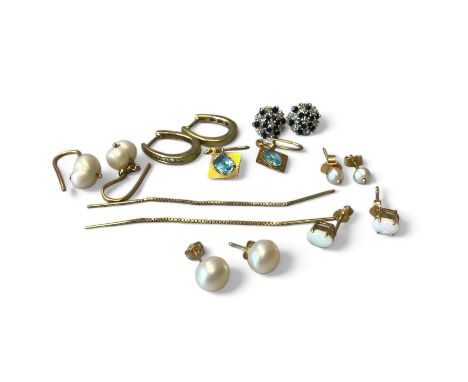 A collection of gold earrings. To include a pair of 9ct gold diamond set hoop earrings; a pair of white opal studs in 9ct gol