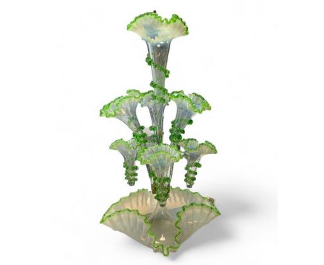 A Vaseline glass epergne with seven branches. Approximate total height 56cm.   Condition: Overall generally good, some small 