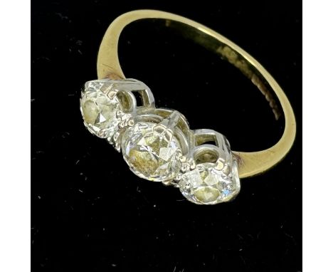 An 18ct gold diamond trilogy ring, set with three Old European cut diamonds. The central stone has a spread equivalent to 0.5