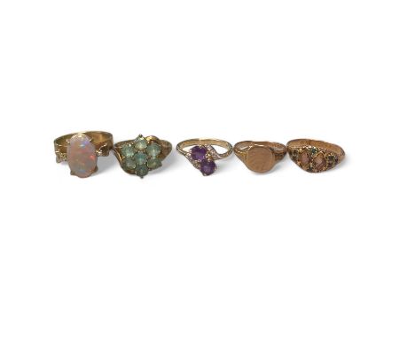A collection of gold dress rings. Featuring a 15ct gold paste set ring, size M; an opal dress ring, stamped 9ct to the shank,