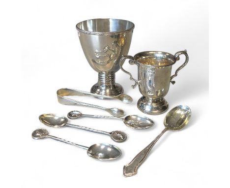 A silver goblet and a silver trophy cup, four silver spoons and a nip. Total approximate weight 215 grams