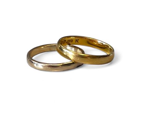 A 22ct yellow gold band ring Size 'N'  Approximate weight 2.9 grams Also a 9ct yellow gold band ring size 'O'  Approximate we