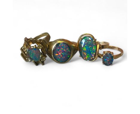 A group of four opal triplet dress rings in yellow precious metal, testing as gold. Featuring a brutalist style ring featurin
