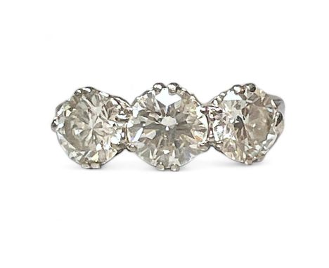 A three stone diamond dress ring, set with an estimated total carat weight of 2.43 carats of diamond.  Set with a central rou