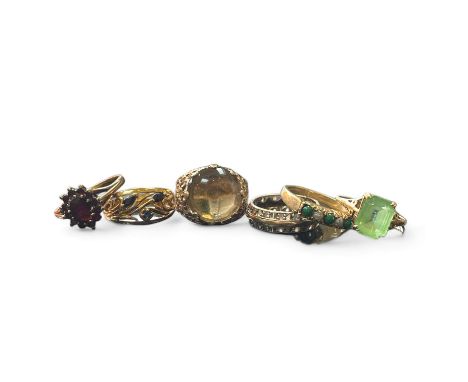 A collection of six gem set dress rings. To comprise a a 9ct garnet cluster ring, size P; a yellow precious metal, tested as 