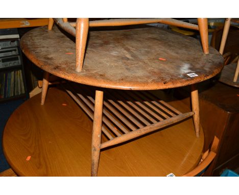 AN ERCOL 1960'S ELM AND BEECH OVAL TOPPED COFFEE TABLE with spindled undertier (in need of restoration)