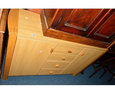A LIGHT OAK FINISH SIDEBOARD with four drawers central to two cupboard doors, approximate width 126cm x depth 40cm x height 8