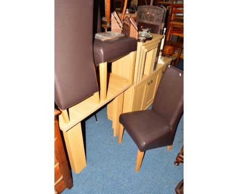 A MODERN LIGHT OAK DINING SUITE comprising of a square topped table, four chairs, a sideboard with three doors and a nest of 