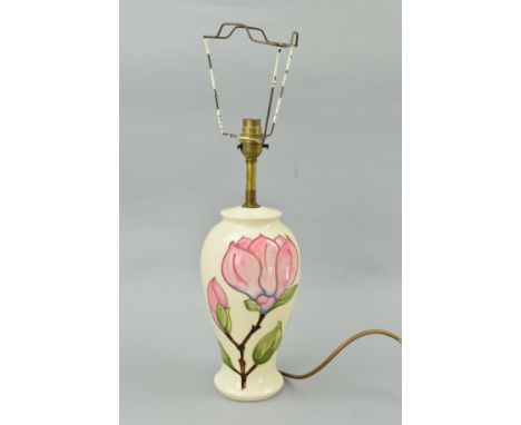 A MOORCROFT POTTERY LAMP BASE, 'Magnolia' pattern on cream ground, impressed and painted marks to base, approximate height of