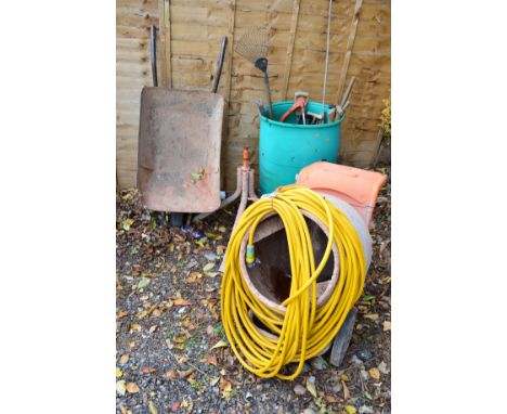 A BELLE MINIMIX 150 CEMENT MIXER with a seperate stand, a wheel barrow and a green garden tub containing various garden tools