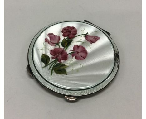 A silver and enamel compact with floral decoration. London 1955 By Henry Clifford Davis. Approx. 132 grams. Est. £150 - £180.