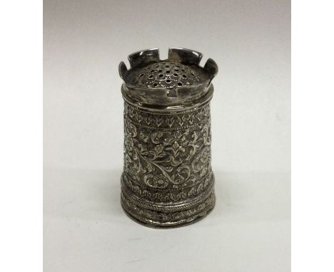 A heavy Indian chased silver pepper grinder. Approx. 80 grams. Est. £80 - £120.