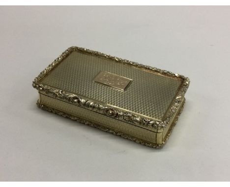 A fine quality large silver gilt snuff box with cast rim to engine turned body. Birmingham. By Nathaniel Mills. Approx. 93 gr